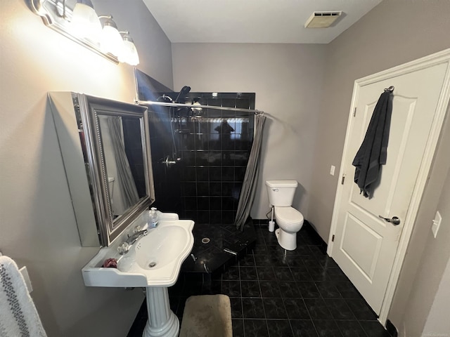 53641 Buckingham Ln, Shelby Twp, MI 48316 - bathroom with a stall shower, toilet, tile patterned floors, and a sink
