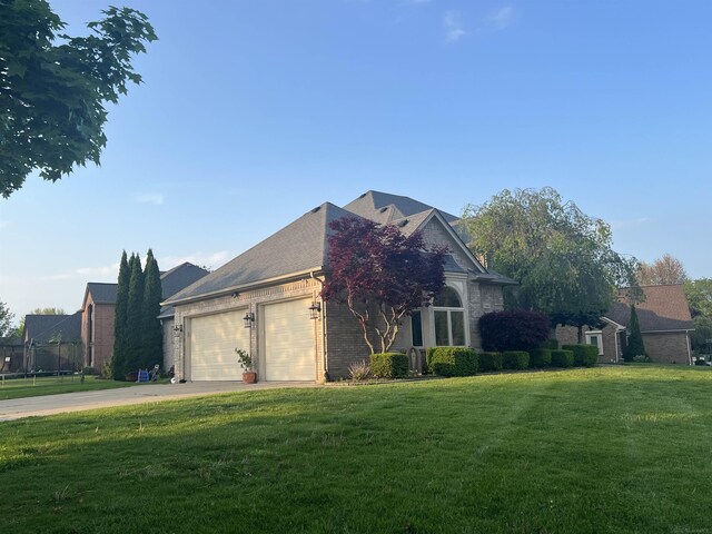 53641 Buckingham Ln, Shelby Twp, MI 48316 - view of side of home with an attached garage, a lawn, driveway, and brick siding