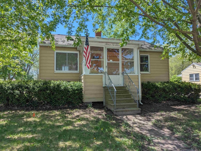 402 E Fisher St, Bay City, MI 48706 - view of front of house with a chimney and entry steps