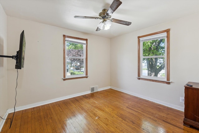 402 E Fisher St, Bay City, MI 48706 - empty room featuring hardwood / wood-style flooring, baseboards, and ceiling fan