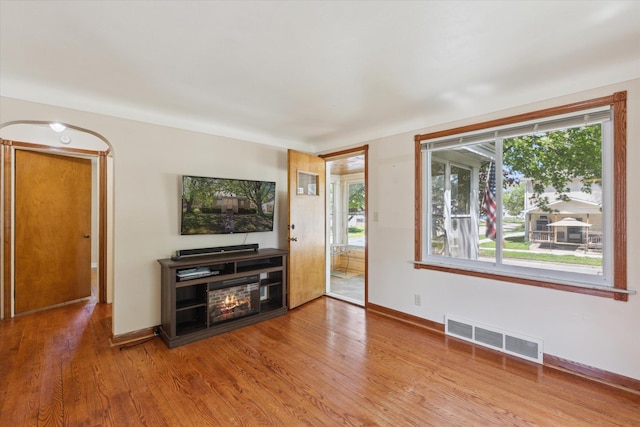 402 E Fisher St, Bay City, MI 48706 - unfurnished living room with wood finished floors and baseboards