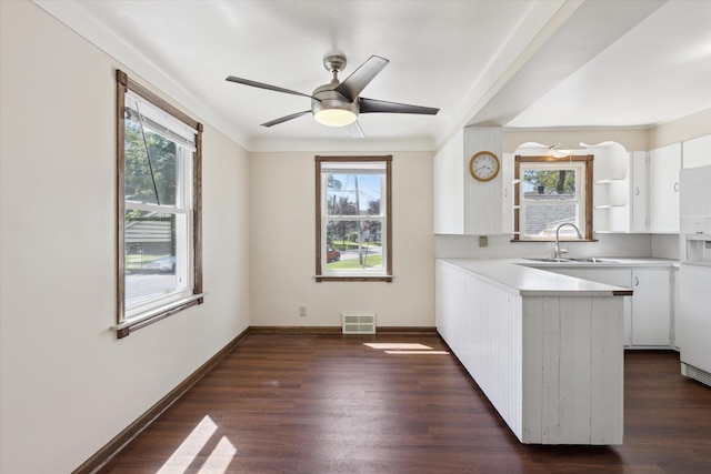 402 E Fisher St, Bay City, MI 48706 - kitchen with a sink, plenty of natural light, a peninsula, and white cabinetry