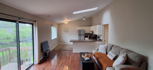 38770 Lanse Creuse St, Harrison Twp, MI 48045 - living area featuring a skylight, lofted ceiling, dark wood-style floors, and baseboards
