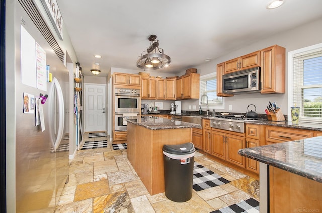 38186 Jefferson Ave, Harrison Twp, MI 48045 - kitchen featuring appliances with stainless steel finishes, stone tile floors, a sink, recessed lighting, and dark stone countertops