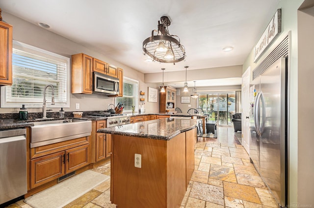 38186 Jefferson Ave, Harrison Twp, MI 48045 - kitchen featuring appliances with stainless steel finishes, a sink, stone tile floors, a peninsula, and plenty of natural light