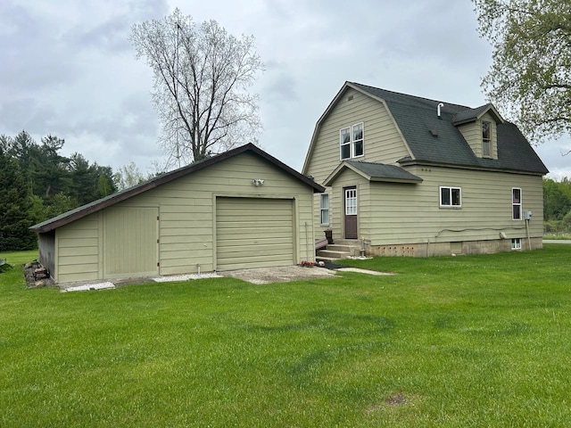 4550 Calhoun Rd, Beaverton, MI 48612 - rear view of property with a lawn, a gambrel roof, an outbuilding, a shingled roof, and entry steps