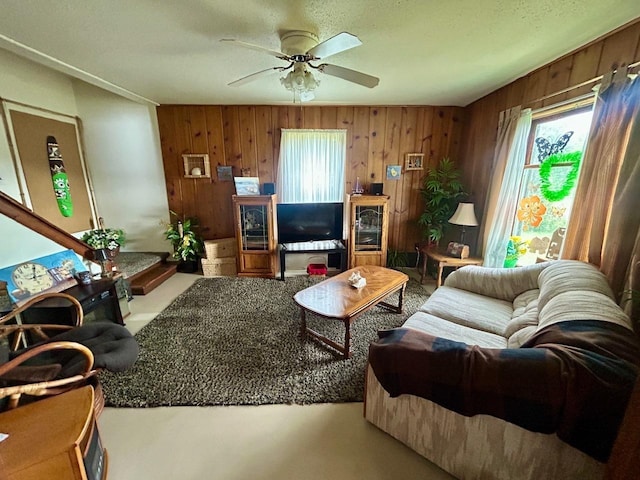 4550 Calhoun Rd, Beaverton, MI 48612 - living area featuring a ceiling fan and wooden walls