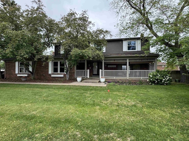4283 Snoal Ln, Shelby Twp, MI 48316 - view of front facade with a porch, a front lawn, and brick siding