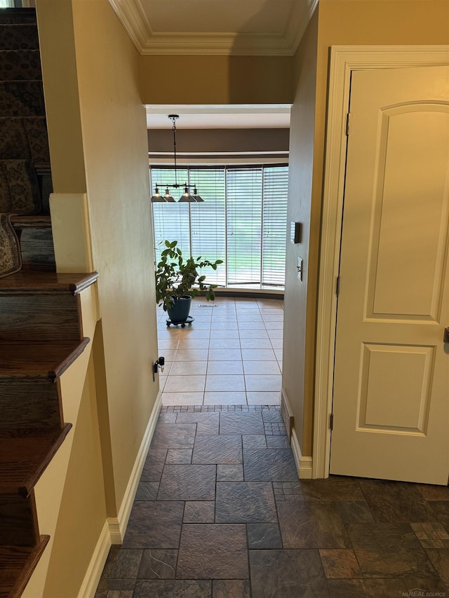 4283 Snoal Ln, Shelby Twp, MI 48316 - hall featuring baseboards, ornamental molding, stone tile floors, and a chandelier