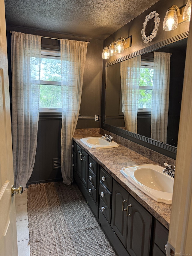 4283 Snoal Ln, Shelby Twp, MI 48316 - bathroom featuring a textured ceiling, double vanity, and tile patterned flooring
