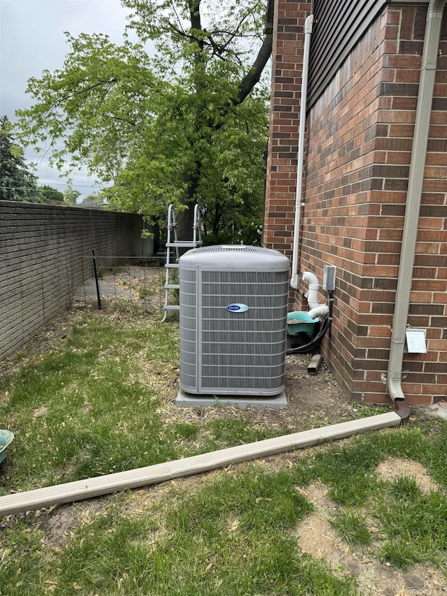 4283 Snoal Ln, Shelby Twp, MI 48316 - exterior view of central AC unit, fence, and brick siding