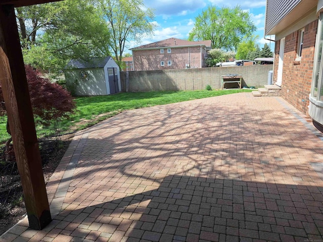 4283 Snoal Ln, Shelby Twp, MI 48316 - view of patio with a storage unit and an outdoor structure