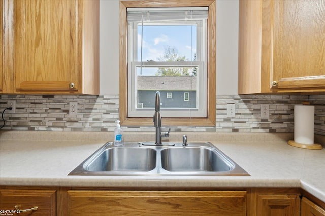 1497 Parke St, Rochester Hills, MI 48307 - kitchen featuring a sink, light countertops, and decorative backsplash