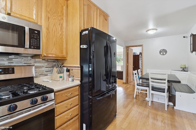 1497 Parke St, Rochester Hills, MI 48307 - kitchen with stainless steel appliances, tasteful backsplash, light wood-type flooring, and light countertops