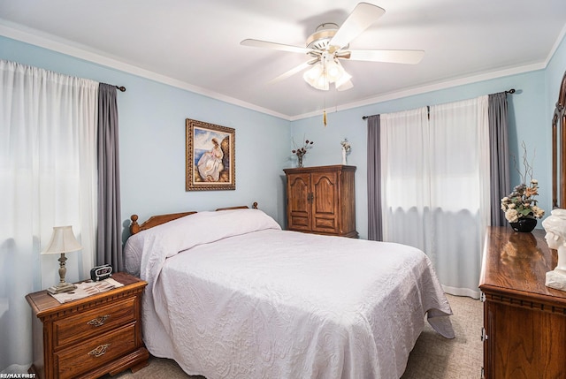 bedroom with ornamental molding, ceiling fan, and carpet floors
