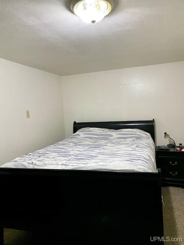 213 N Fifth St, Marquette, MI 49855 - carpeted bedroom featuring a textured ceiling