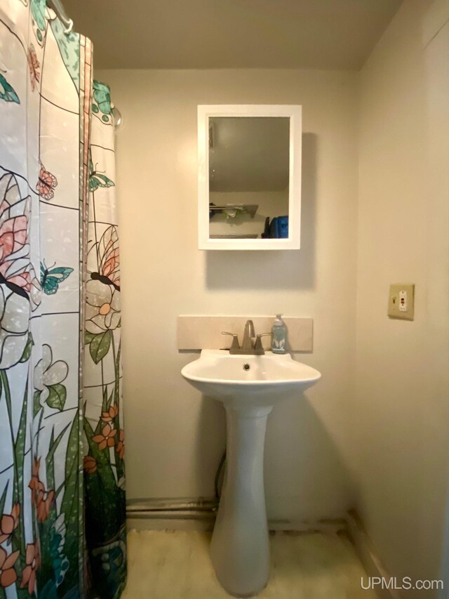 213 N Fifth St, Marquette, MI 49855 - full bathroom with baseboards, a sink, and curtained shower