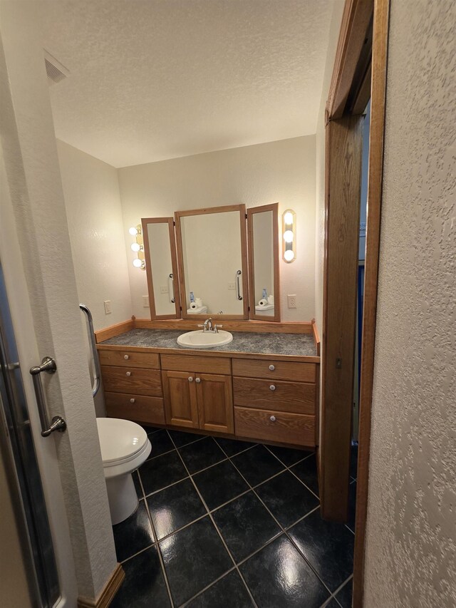 41 W River Dr, Gladwin, MI 48624 - half bathroom with toilet, tile patterned flooring, vanity, a textured ceiling, and a textured wall