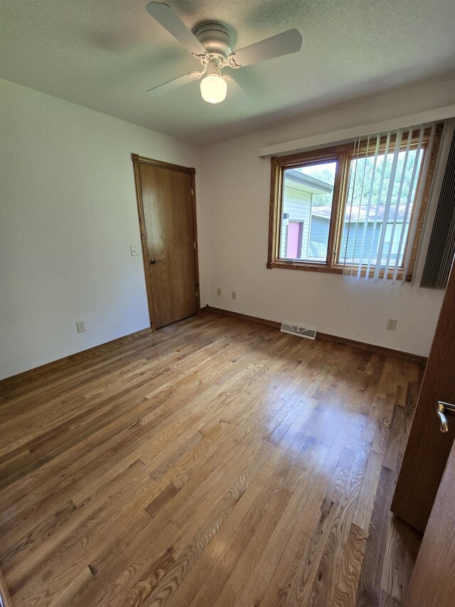 41 W River Dr, Gladwin, MI 48624 - unfurnished bedroom with wood finished floors and a ceiling fan