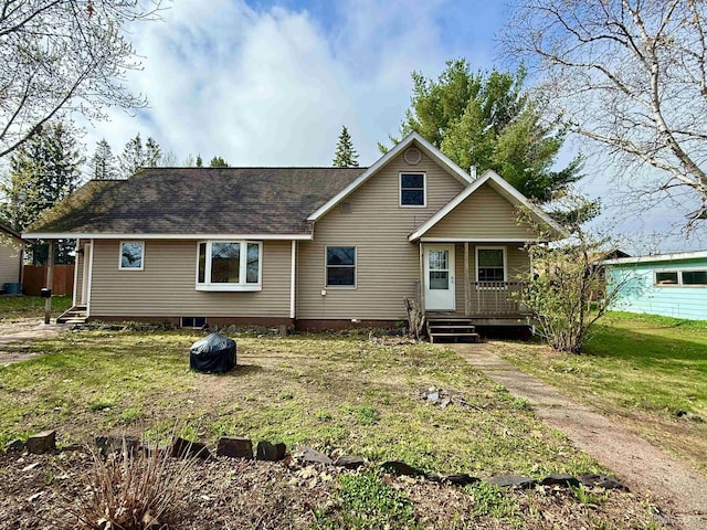 730 Elliott Ave, Ishpeming, MI 49855 - rear view of property featuring a yard, a shingled roof, and central AC
