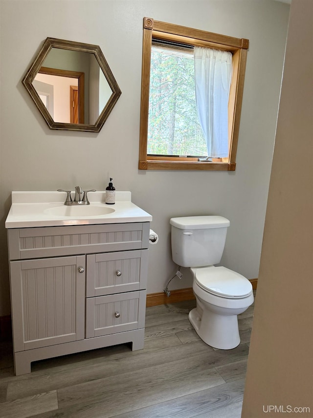 730 Elliott Ave, Ishpeming, MI 49855 - bathroom featuring toilet, wood finished floors, vanity, and baseboards