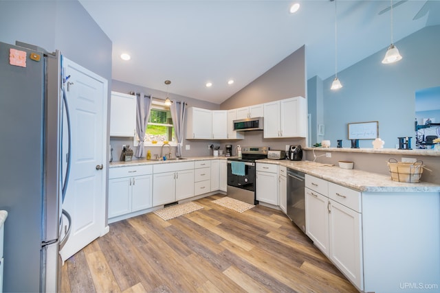 106 Green Rd, Michigamme, MI 49861 - kitchen with stainless steel appliances, a sink, white cabinetry, light wood-style flooring, and recessed lighting