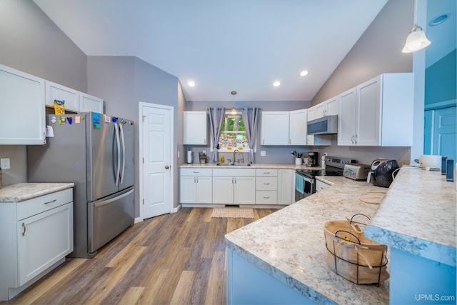 106 Green Rd, Michigamme, MI 49861 - kitchen featuring appliances with stainless steel finishes, a sink, lofted ceiling, wood finished floors, and light countertops