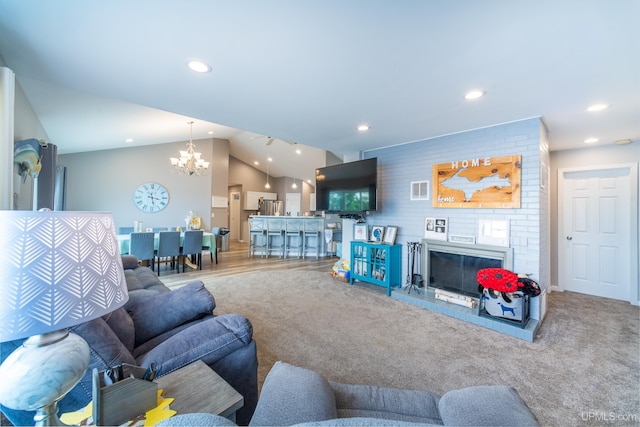 106 Green Rd, Michigamme, MI 49861 - living room featuring a chandelier, recessed lighting, vaulted ceiling, and a fireplace