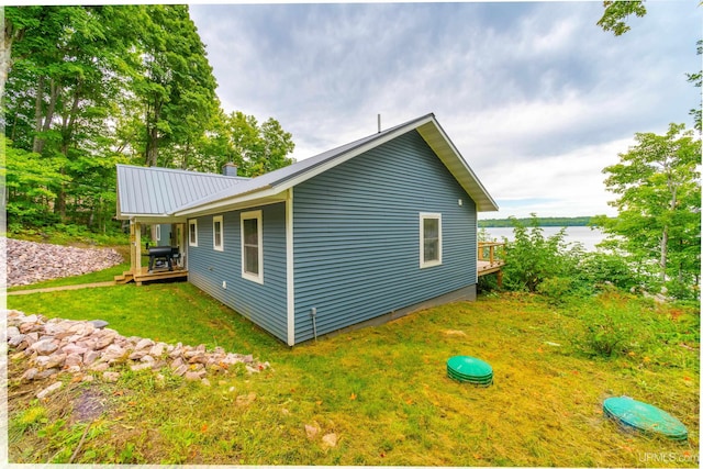 106 Green Rd, Michigamme, MI 49861 - view of side of property featuring a yard, metal roof, and a deck with water view