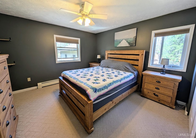 14 Arrowhead Dr, Marquette, MI 49855 - bedroom with light carpet, a baseboard radiator, baseboards, and ceiling fan