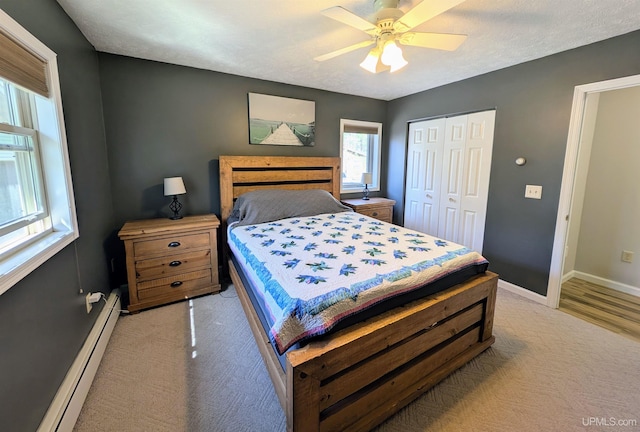 14 Arrowhead Dr, Marquette, MI 49855 - bedroom featuring a baseboard radiator, baseboards, light carpet, and a closet