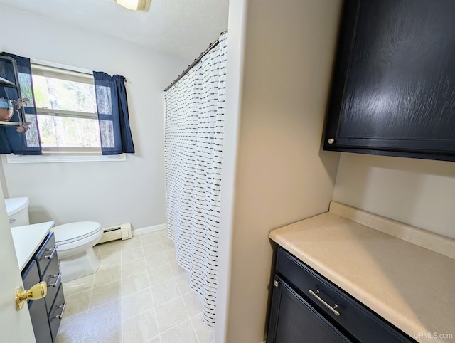 14 Arrowhead Dr, Marquette, MI 49855 - full bathroom with vanity, a baseboard radiator, toilet, tile patterned flooring, and a shower with curtain