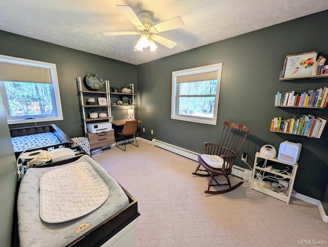14 Arrowhead Dr, Marquette, MI 49855 - carpeted home office with baseboard heating, a textured ceiling, a ceiling fan, and baseboards