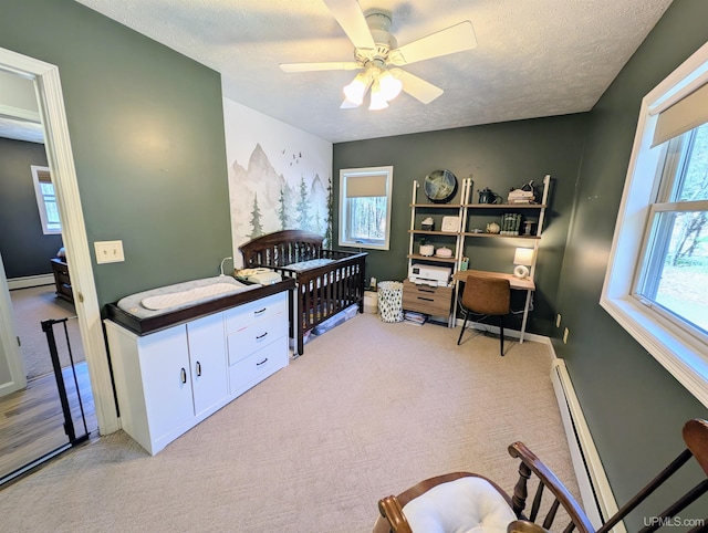 14 Arrowhead Dr, Marquette, MI 49855 - bedroom featuring multiple windows, light carpet, a baseboard heating unit, and a textured ceiling