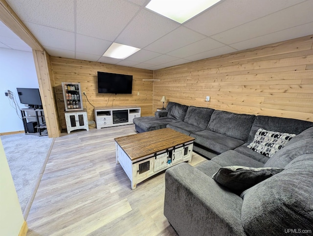 14 Arrowhead Dr, Marquette, MI 49855 - living room featuring wooden walls, a paneled ceiling, and light wood finished floors