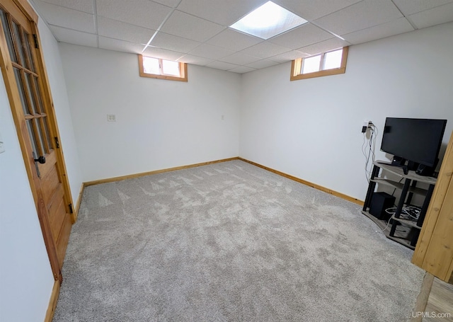 14 Arrowhead Dr, Marquette, MI 49855 - below grade area featuring a drop ceiling, carpet flooring, baseboards, and plenty of natural light