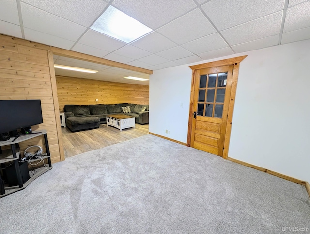 14 Arrowhead Dr, Marquette, MI 49855 - carpeted living room with wood walls, a paneled ceiling, and baseboards
