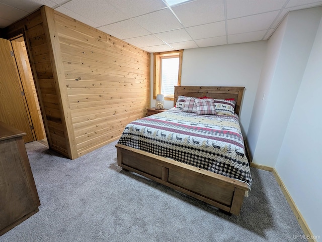 14 Arrowhead Dr, Marquette, MI 49855 - carpeted bedroom featuring wood walls, a drop ceiling, and baseboards