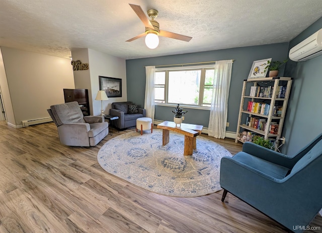 14 Arrowhead Dr, Marquette, MI 49855 - sitting room with a baseboard heating unit, wood finished floors, an AC wall unit, a ceiling fan, and a textured ceiling