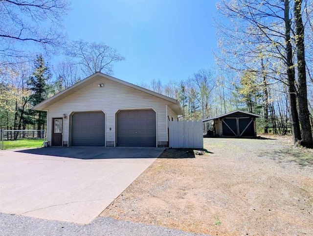14 Arrowhead Dr, Marquette, MI 49855 - view of property exterior with an outbuilding, fence, and a garage