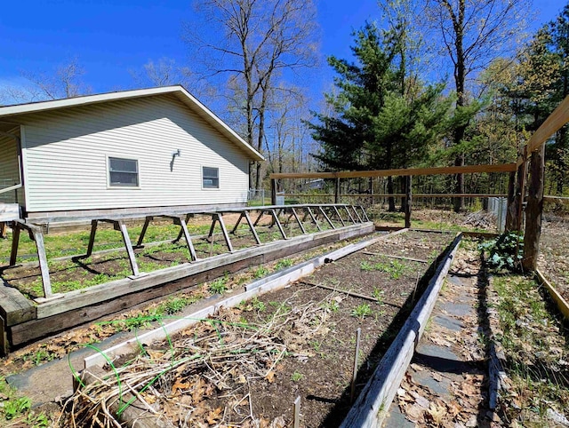 14 Arrowhead Dr, Marquette, MI 49855 - view of home's exterior featuring a vegetable garden and fence
