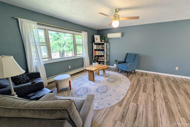14 Arrowhead Dr, Marquette, MI 49855 - sitting room with wood finished floors, baseboards, a wall mounted AC, a ceiling fan, and a textured ceiling