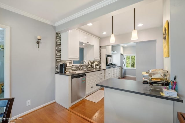 1131 Boyd St, Troy, MI 48083 - kitchen with appliances with stainless steel finishes, a sink, dark countertops, white cabinets, and decorative backsplash