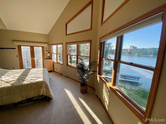 18918 Canal Rd, Houghton, MI 49931 - bedroom featuring a water view, light colored carpet, multiple windows, baseboards, and high vaulted ceiling