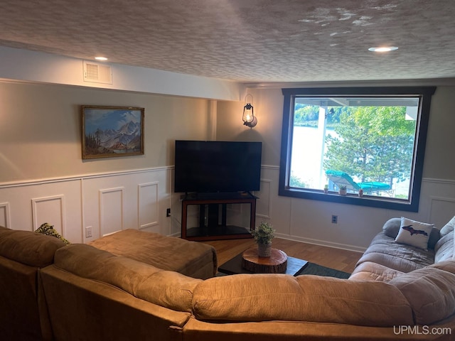 18918 Canal Rd, Houghton, MI 49931 - living area featuring wood finished floors, a decorative wall, and wainscoting