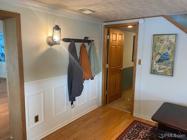 18918 Canal Rd, Houghton, MI 49931 - hallway featuring wood finished floors, crown molding, and a textured ceiling