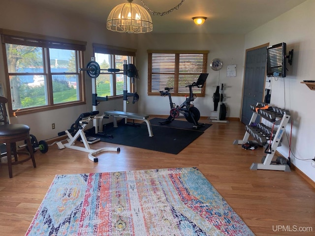 18918 Canal Rd, Houghton, MI 49931 - exercise area with a chandelier, wood finished floors, and baseboards