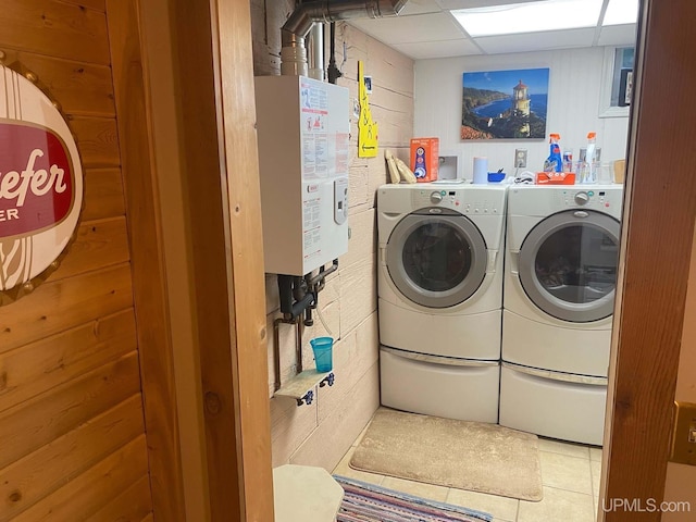 18918 Canal Rd, Houghton, MI 49931 - clothes washing area with independent washer and dryer, tile patterned flooring, and water heater