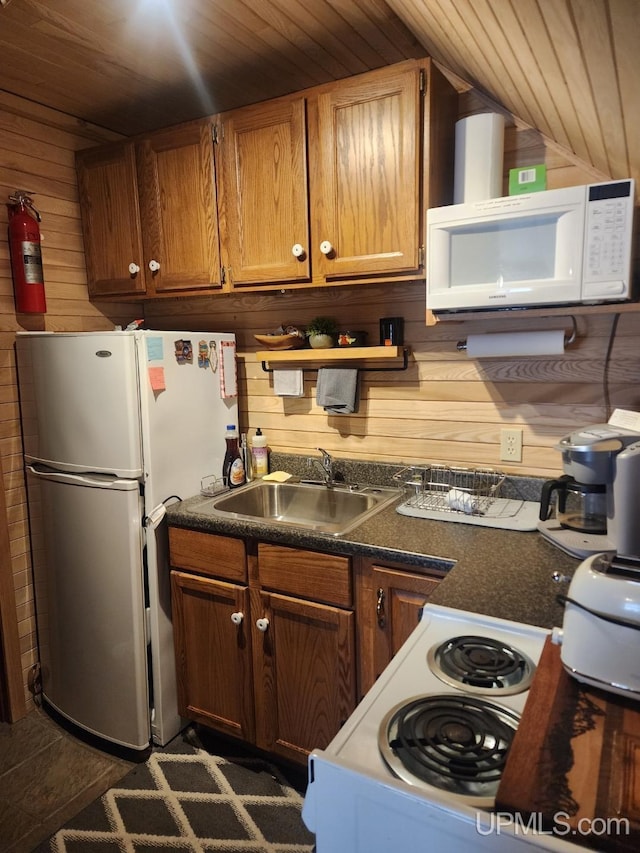 18918 Canal Rd, Houghton, MI 49931 - kitchen with white appliances, a sink, wooden ceiling, wood walls, and lofted ceiling