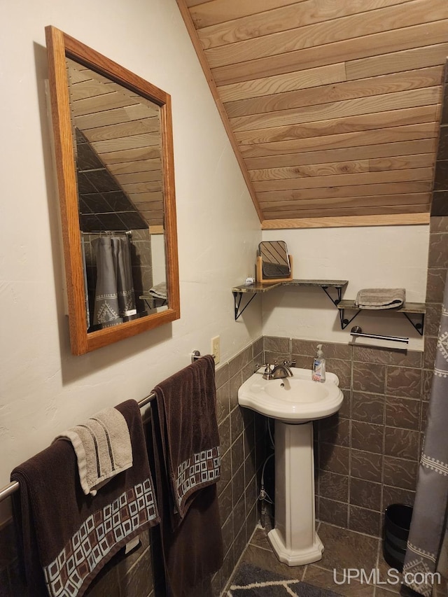 18918 Canal Rd, Houghton, MI 49931 - full bath with tile walls, wainscoting, wood ceiling, and a sink